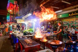 Chef Cooking Food At Street Side Restaurant In Yaowarat Road, Bangkok