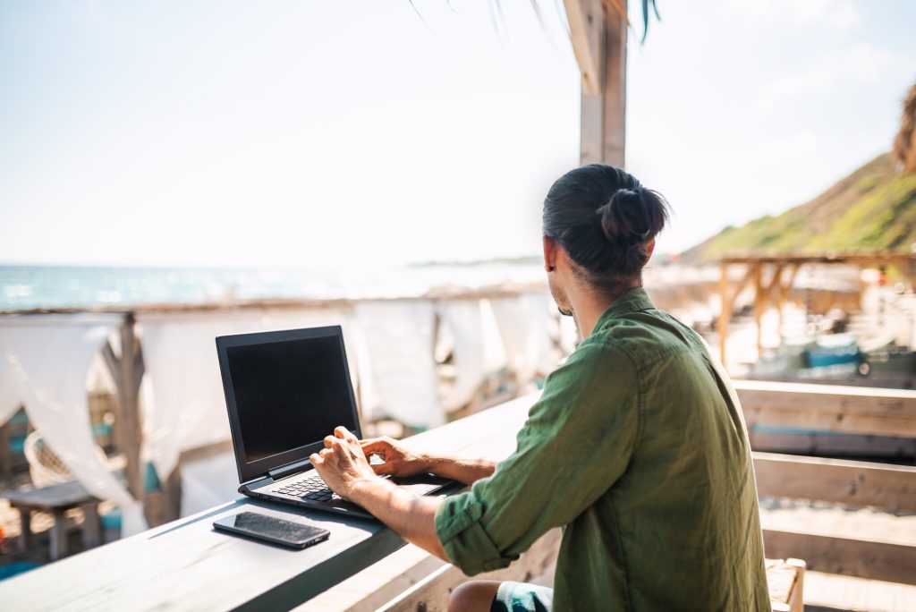 Digital Nomad On The Beach Enjoying His Day.